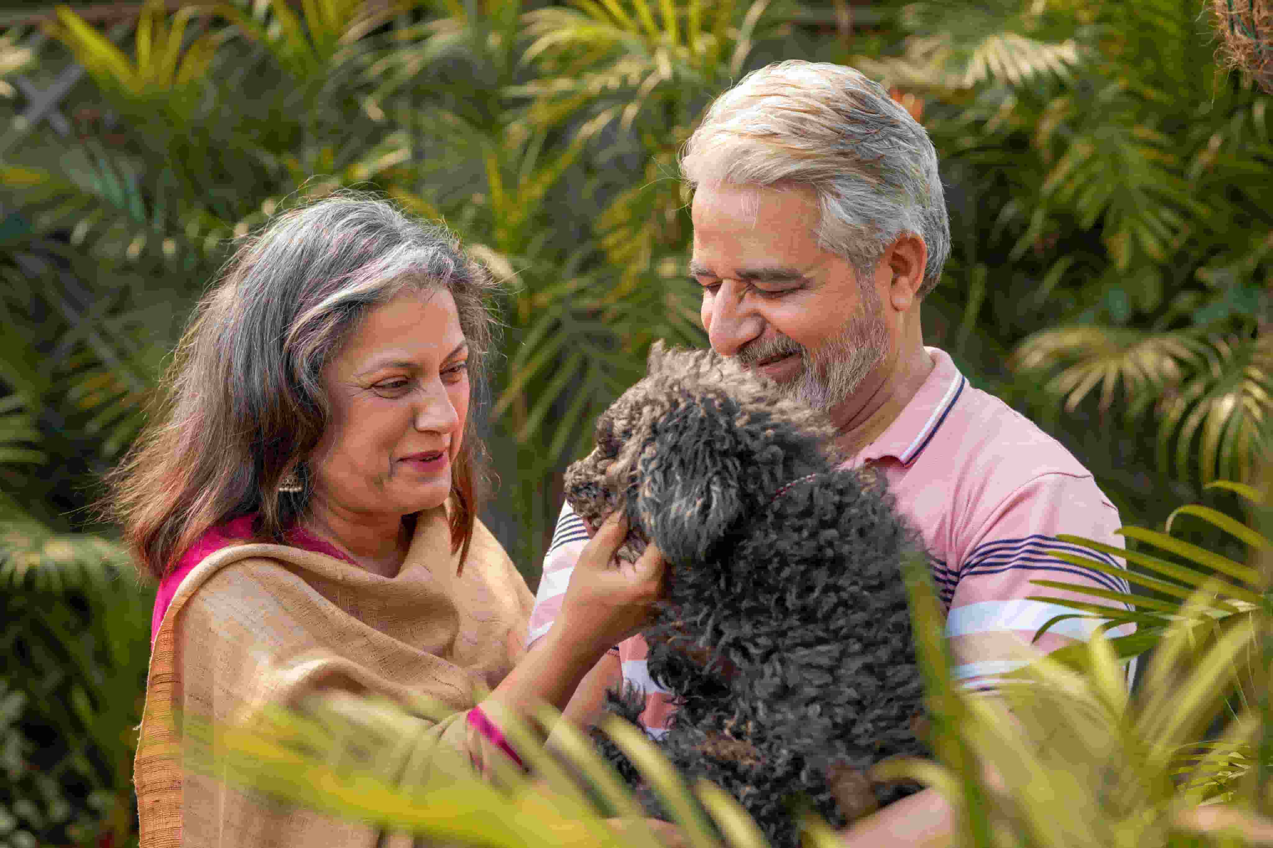 Family members holding a pet
